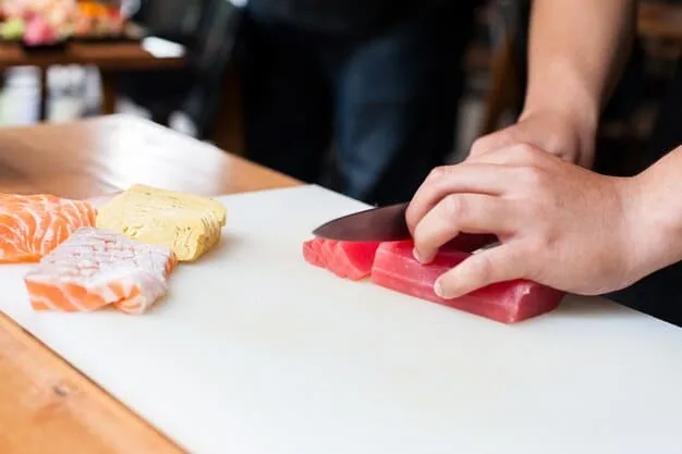 A close-up shot of a chef expertly slicing a block of sashimi-grade tuna, showcasing the rich color and texture of the fish.