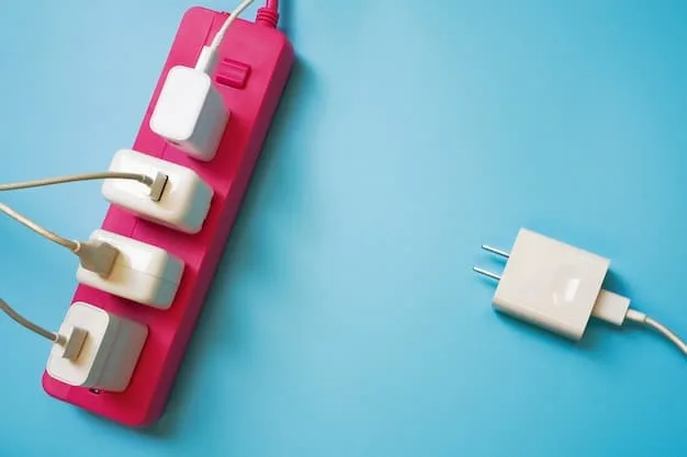 A close-up photo of a universal travel adapter plugged into a Japanese wall socket, with a smartphone charging cable connected to the adapter.