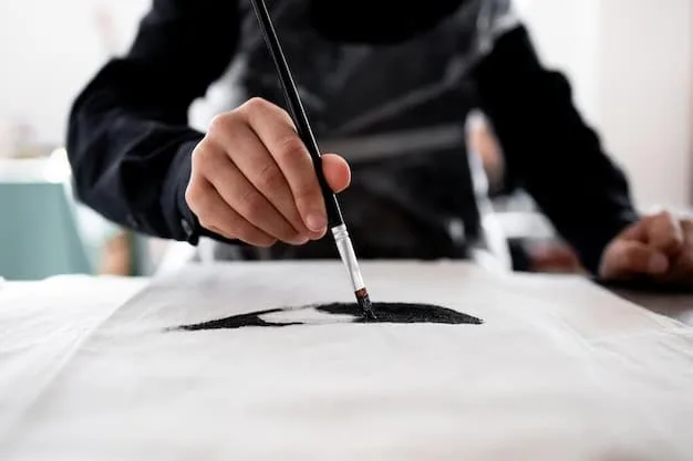 A master sumi-e artist's hands carefully grinding an ink stick on an ink stone, surrounded by traditional sumi-e brushes and a water holder, emphasizing the preparation process.