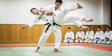 Judo practitioner in mid-throw, showcasing the dynamism of Japanese martial arts.