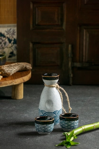 Close-up of a beautifully crafted Japanese tea set, showcasing the intricate details and delicate glazing of the pottery. The set includes a teapot, several small cups, and a bamboo whisk.