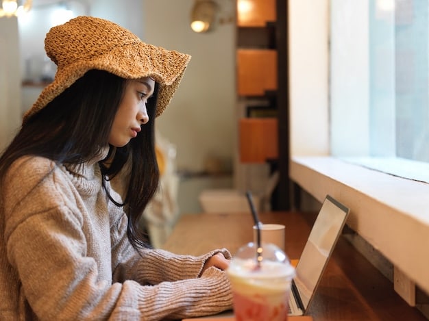 A traveler sitting in a modern Japanese coffee shop, connecting to the free Wi-Fi on their laptop while enjoying a cup of coffee. The scene illustrates the integration of public Wi-Fi in everyday life.
