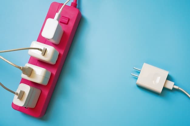A close-up photo of a universal travel adapter plugged into a Japanese wall socket, with a smartphone charging cable connected to the adapter.