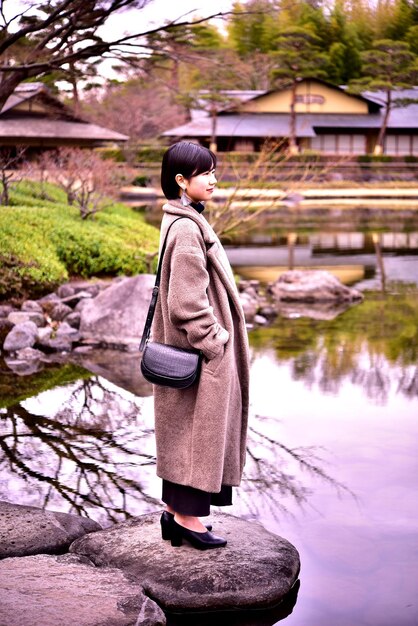 A person wearing comfortable walking shoes and lightweight clothing, standing in front of a traditional Japanese building, showcasing practical travel attire.