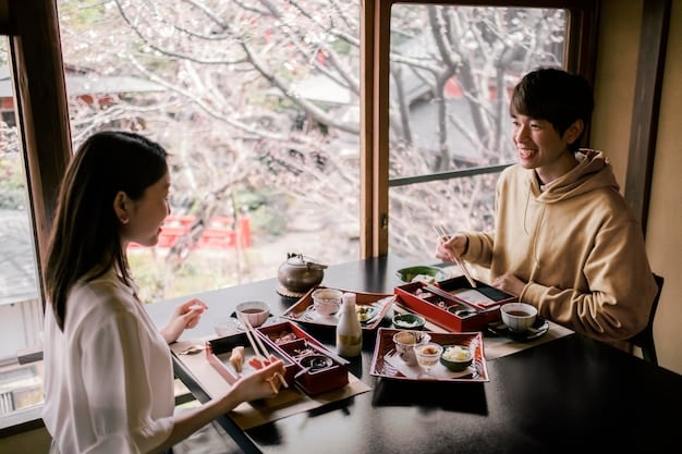 A group of tourists sitting at a traditional tatami mat table in a Japanese restaurant. They are using chopsticks to eat various dishes, with a serene garden visible through the window.