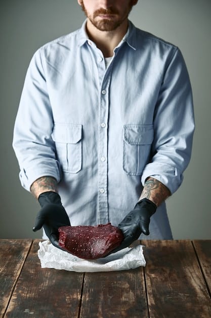 A butcher carefully slicing a Wagyu ribeye steak, showcasing the marbling and fat content. The butcher should be wearing gloves and using professional equipment, emphasizing the care and expertise involved in handling high-quality Wagyu beef.