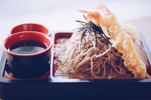A close-up of Kitakata ramen, highlighting the wide, flat, and wavy noodles in a clear pork bone and soy sauce broth, topped with chashu pork, menma, and green onions, emphasizing the textural contrast.