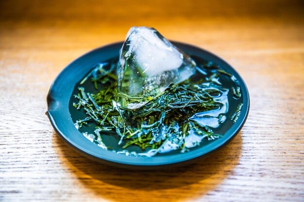 A close-up shot of dried kombu kelp soaking in a clear glass bowl filled with water, showcasing the translucent quality of the kombu and the pristine clarity of the water. The lighting is soft and diffused, highlighting the natural textures and colors.