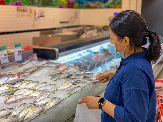A merchant at an Asian supermarket assisting a customer with selecting fresh seafood, highlighting the variety and quality of options available.
