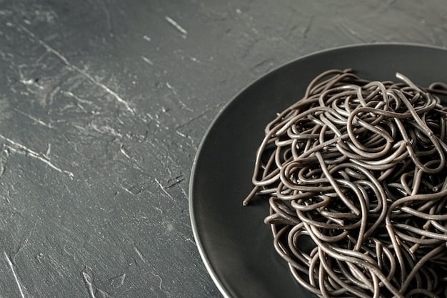 A close-up image of properly cooked and rinsed soba noodles glistening with moisture, ready to be served on a zaru. The focus is on the texture and visual appeal of the noodles.