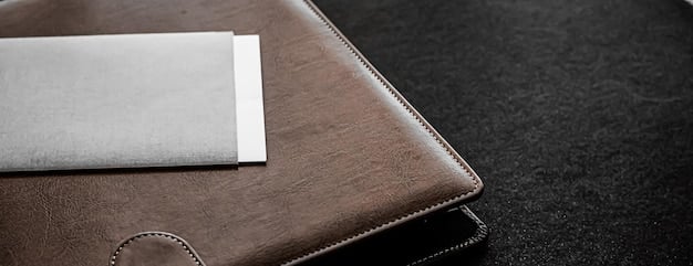 A photograph of a professional-looking leather business card holder on a clean, modern desk. Next to it are several neatly stacked business cards. The focus should be on the presentation and organization of the cards and holder.