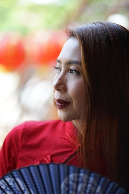 A close-up shot of a Japanese woman in traditional clothing, subtly nodding with a slight smile, showing respect and understanding.