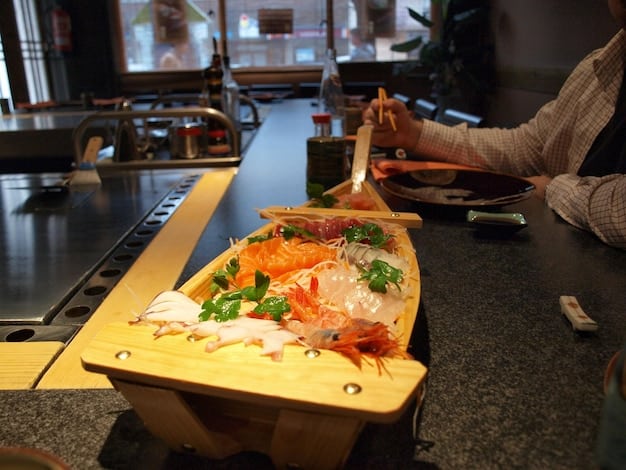 A detailed shot of an open-top sushi restaurant in Tsukiji Outer Market, with fresh seafood on display and a lively atmosphere.