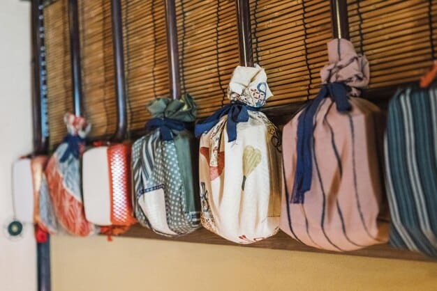 A detailed shot of various Japanese lucky bags (fukubukuro) stacked inside a department store, with shoppers eagerly waiting to purchase them during the New Year's sale. The bags are colorful and wrapped, hinting at their mysterious contents.