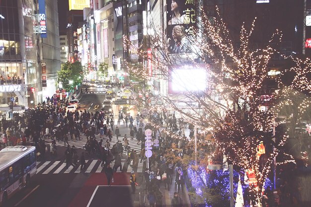 A bustling street in Tokyo during a New Year's sale, with crowds of shoppers eagerly lining up for 