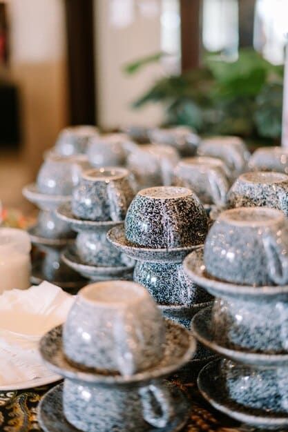 A detailed shot of an exquisite Japanese ceramic tea set on display at a clean, well-organized home goods section of an outlet mall, highlighting intricate patterns and quality craftsmanship.