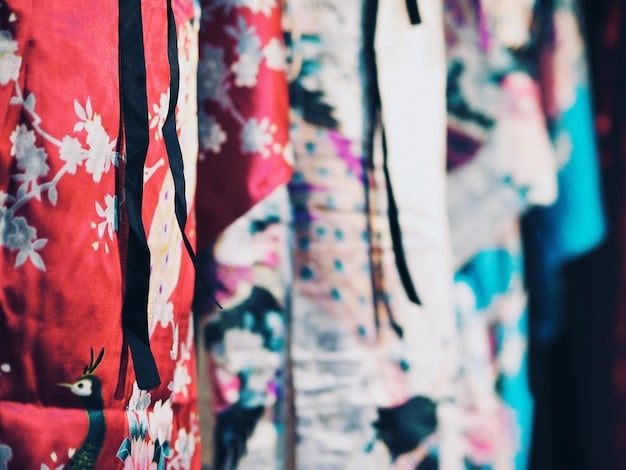 A variety of Furoshiki cloths displayed folded, showing diverse patterns and textures, including floral, geometric, and traditional Japanese motifs, ready for selection.