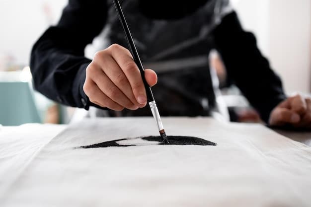 A master sumi-e artist's hands carefully grinding an ink stick on an ink stone, surrounded by traditional sumi-e brushes and a water holder, emphasizing the preparation process.