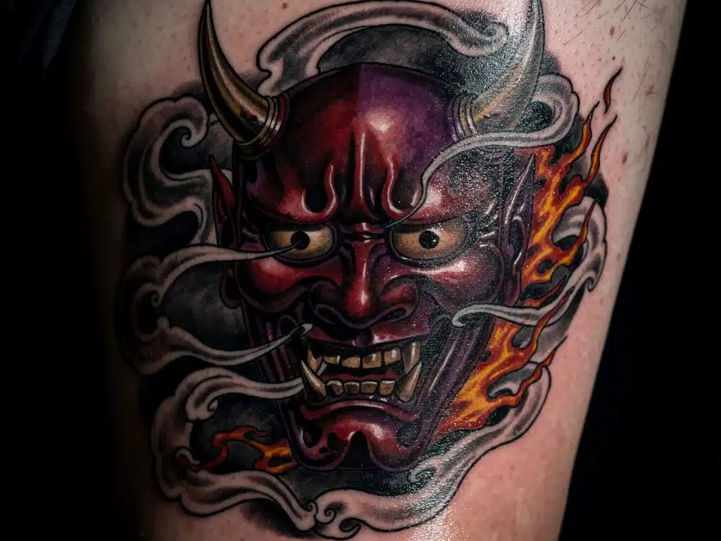Dramatic Hannya mask Japanese tattoo with smoky details